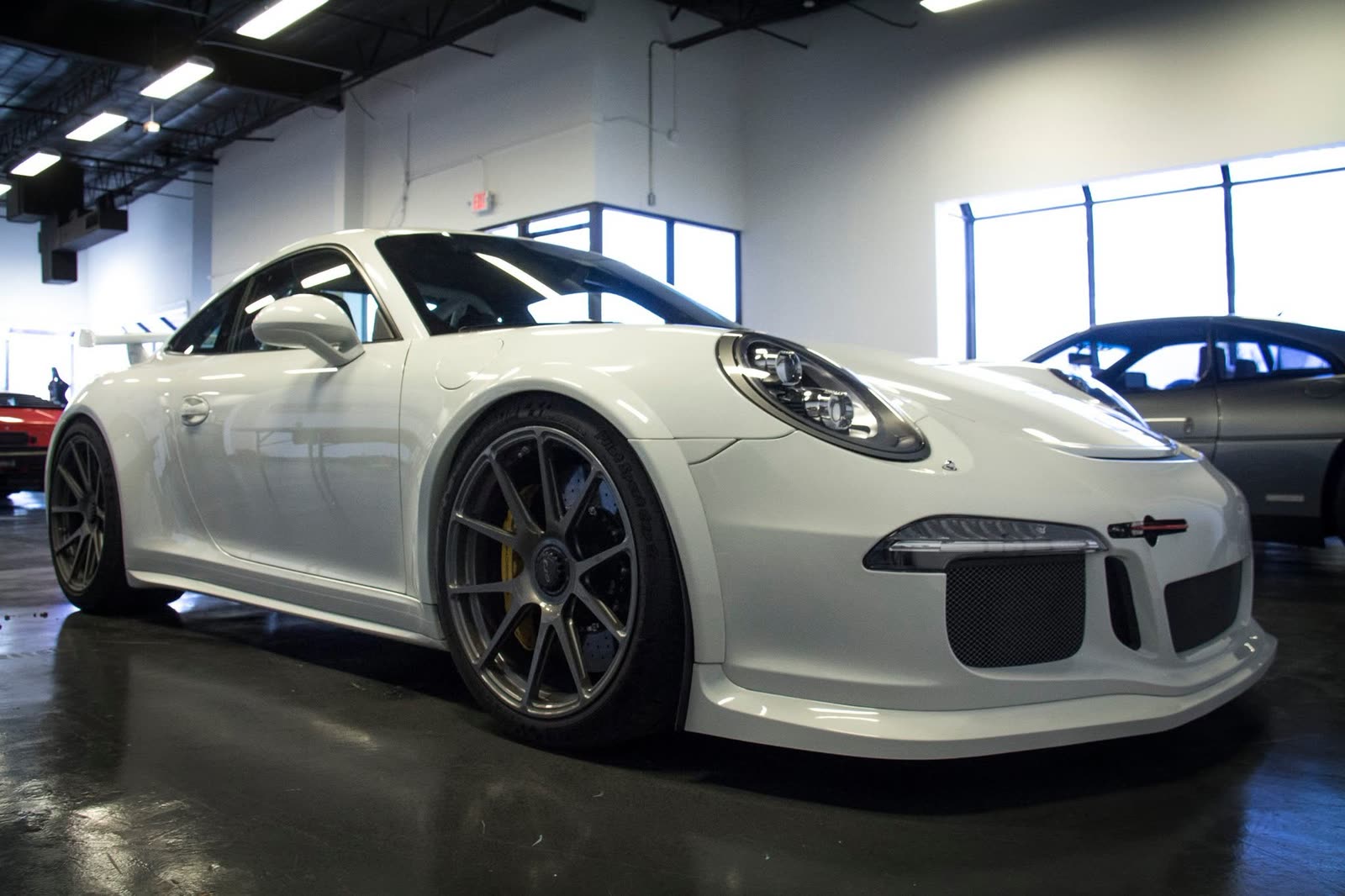 A glossy white Porsche 911 GT3 in the studio
