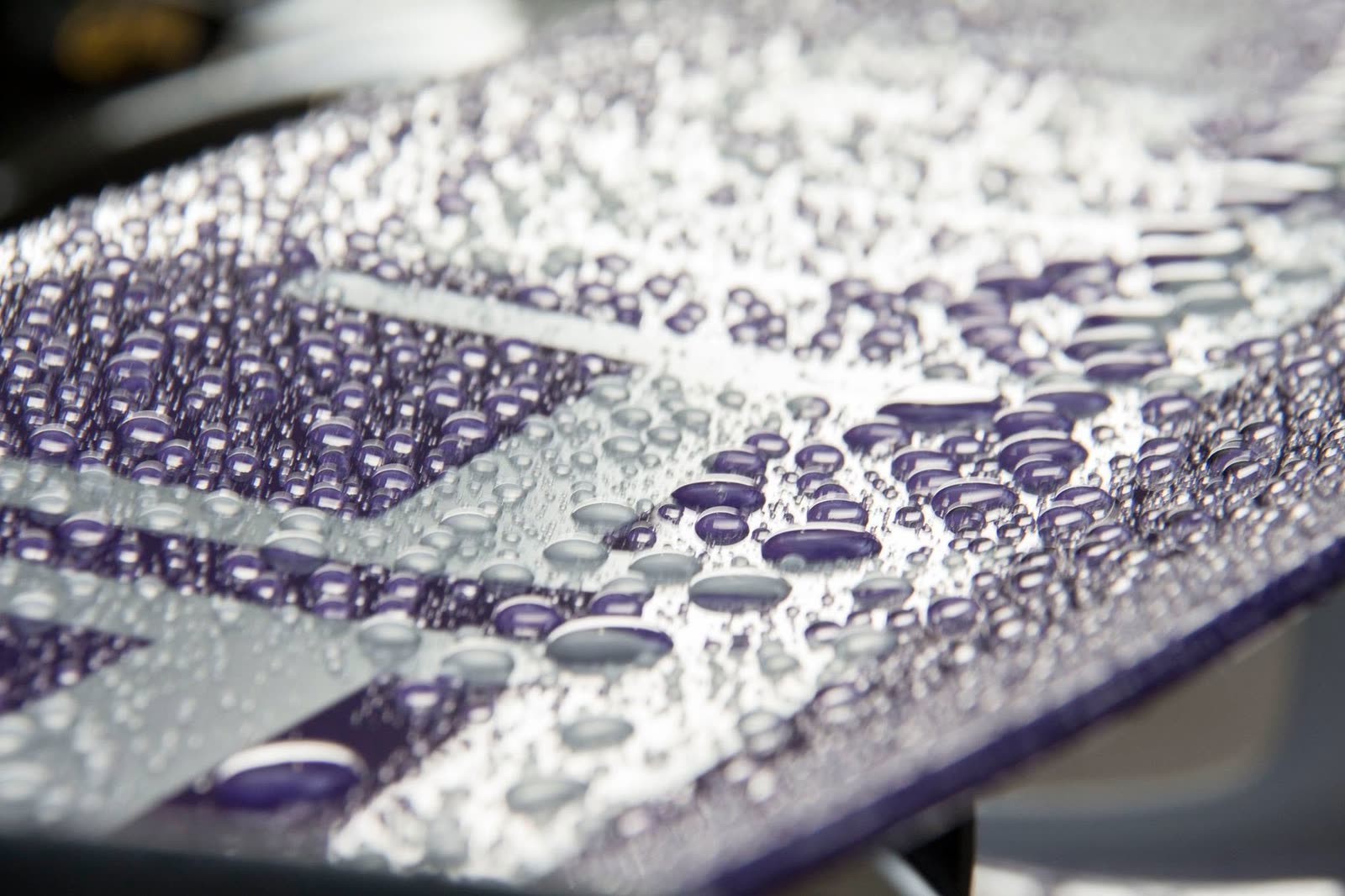 Water beading across coated purple paint