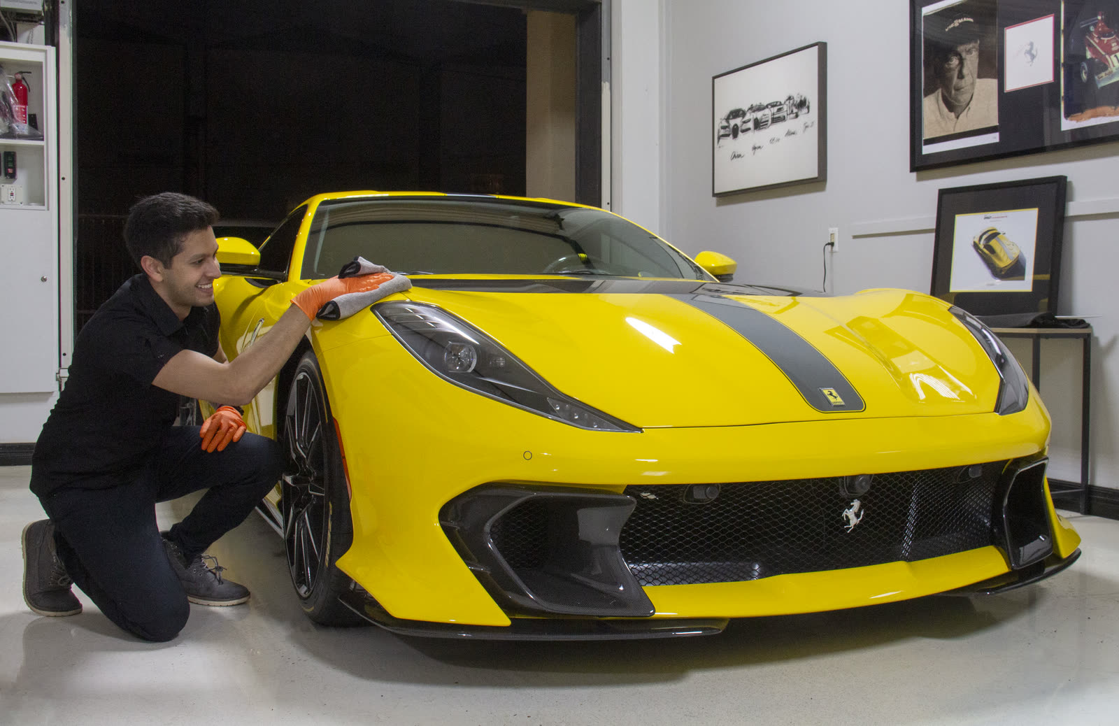 Wiping down the front of a yellow Ferrari 812 Competizione during a film install