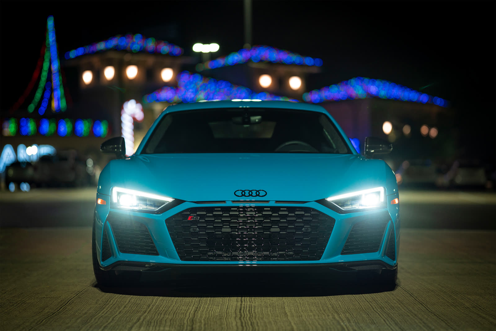 A blue Audi R8 at night